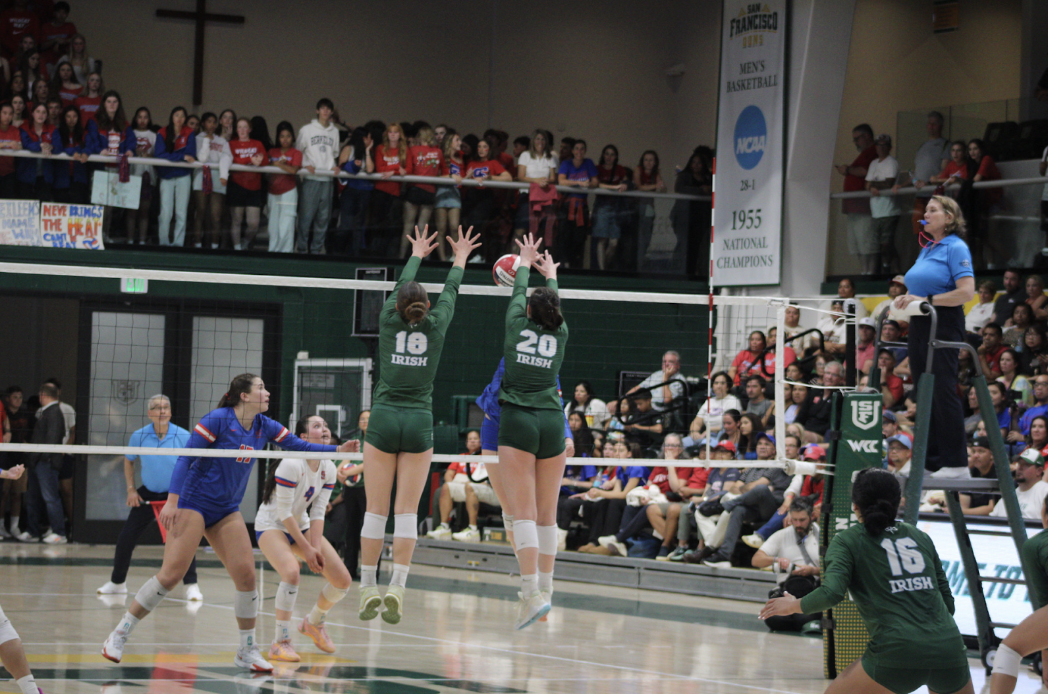 Hazel Nelson ‘25 and Mackenzie Flynn ‘25 fly as they reach to block an SI spike.